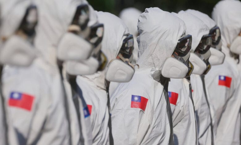 Soldiers disinfect Wanhua district, an area that has one of the most cases of coronavirus disease (COVID-19) in the city, in Taipei