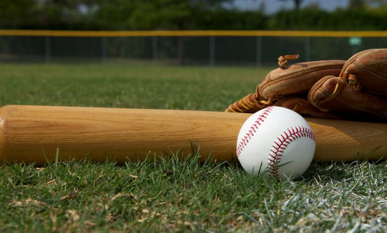 Baseball Bat and Glove on the Field